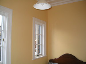 Interior bedroom with smoothly finished ceiling and walls in soft white