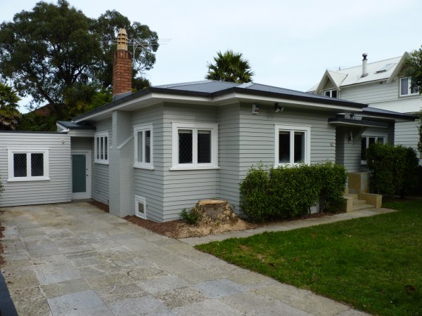 Auckland residential exterior repaint with new gutters and soffits painted in matte black